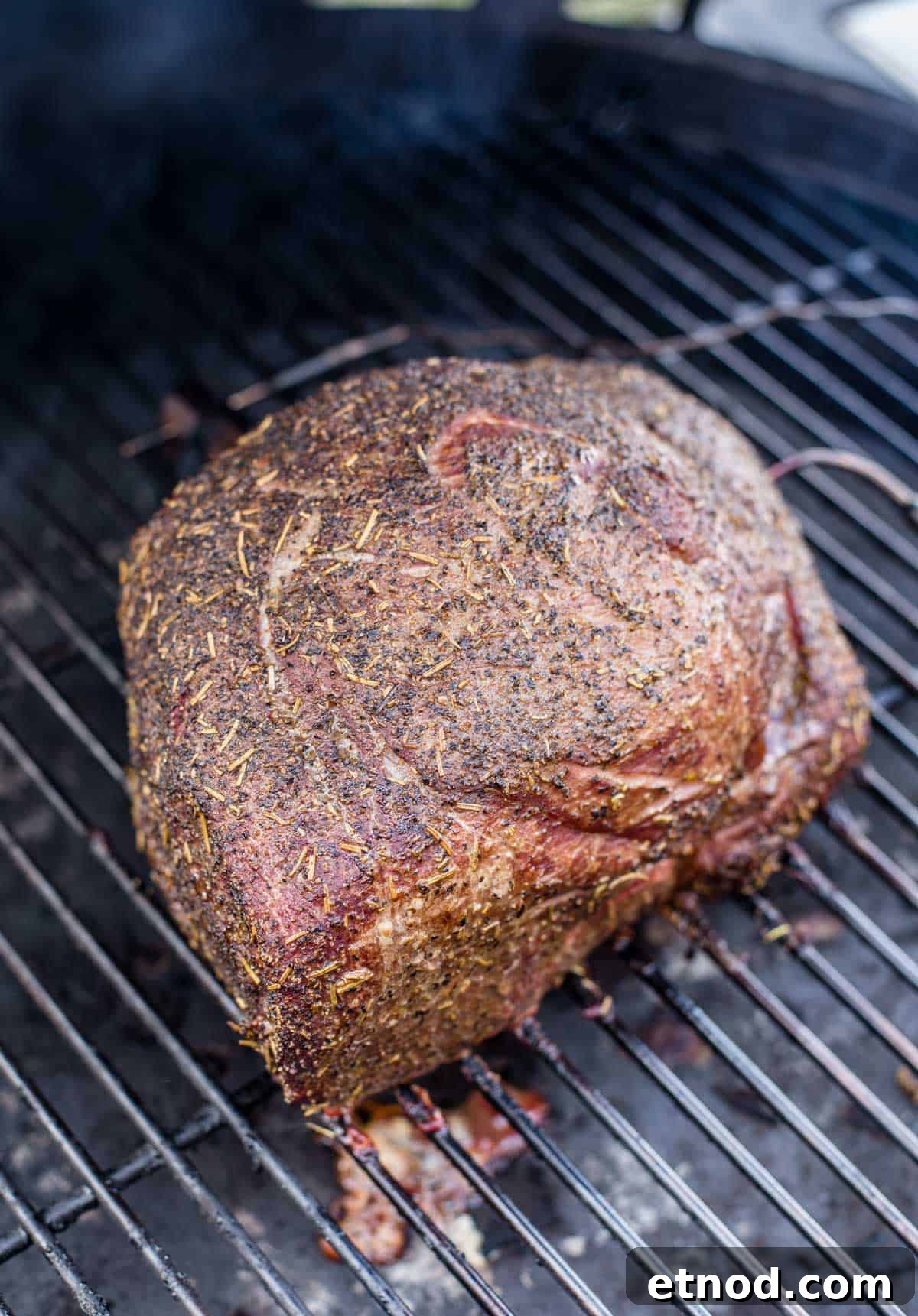 Smoked Herb-Crusted Roast Beef Recipe 5 Smoked beef roast cooking on a smoker