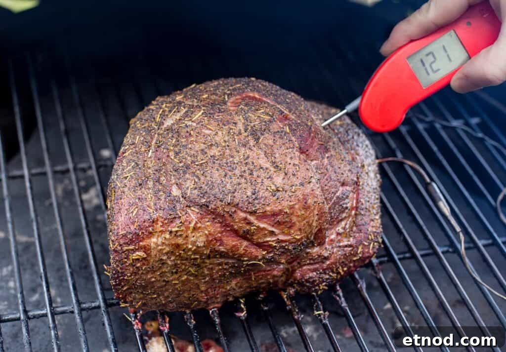 Smoked Herb-Crusted Roast Beef Recipe 6 Taking temperature of a roast using a digital thermometer.