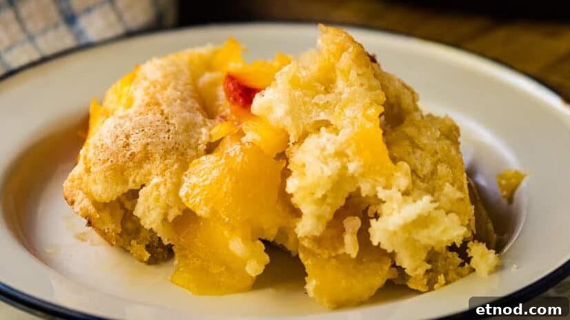 31 Forgotten Grandma Potluck Recipes Worth Bringing Back 16 Plate with peach cobbler and a blue napkin.