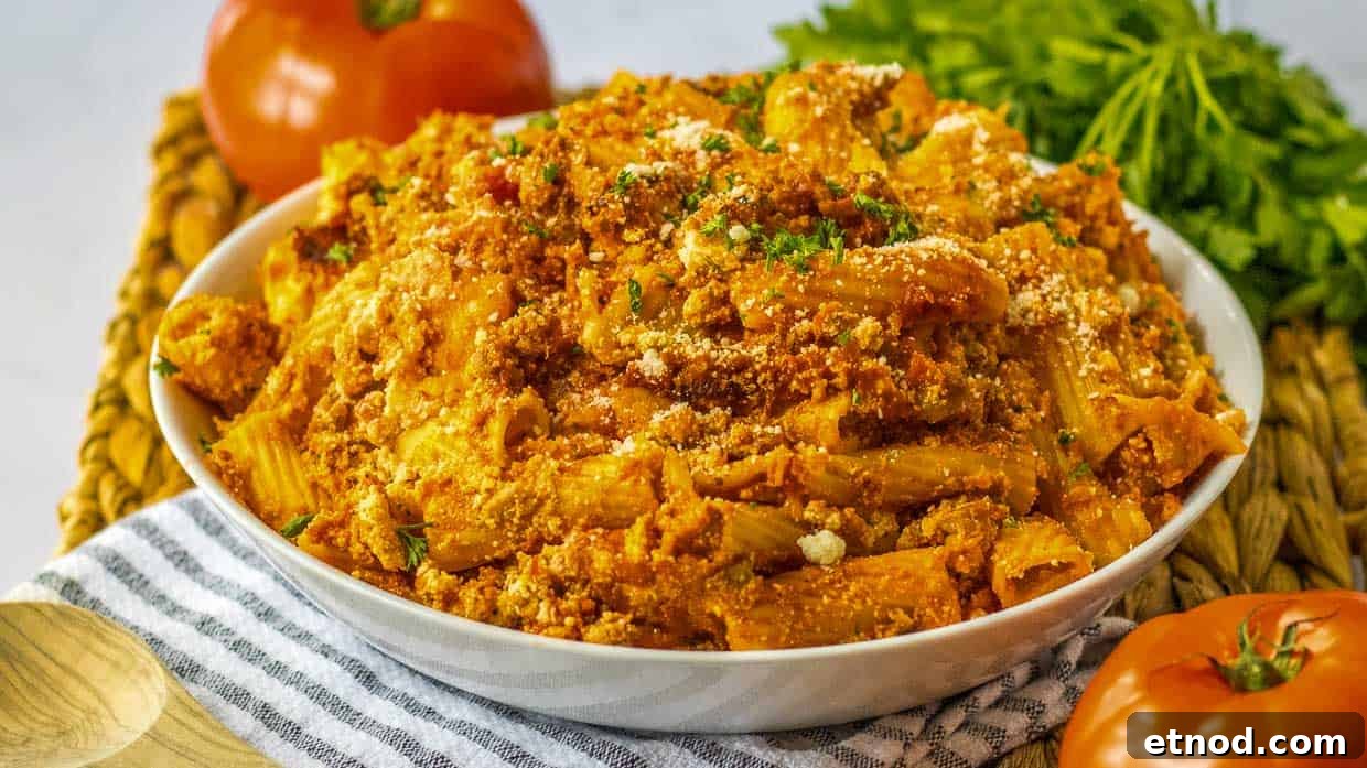 31 Forgotten Grandma Potluck Recipes Worth Bringing Back 21 A bowl of pasta with meat and tomatoes.