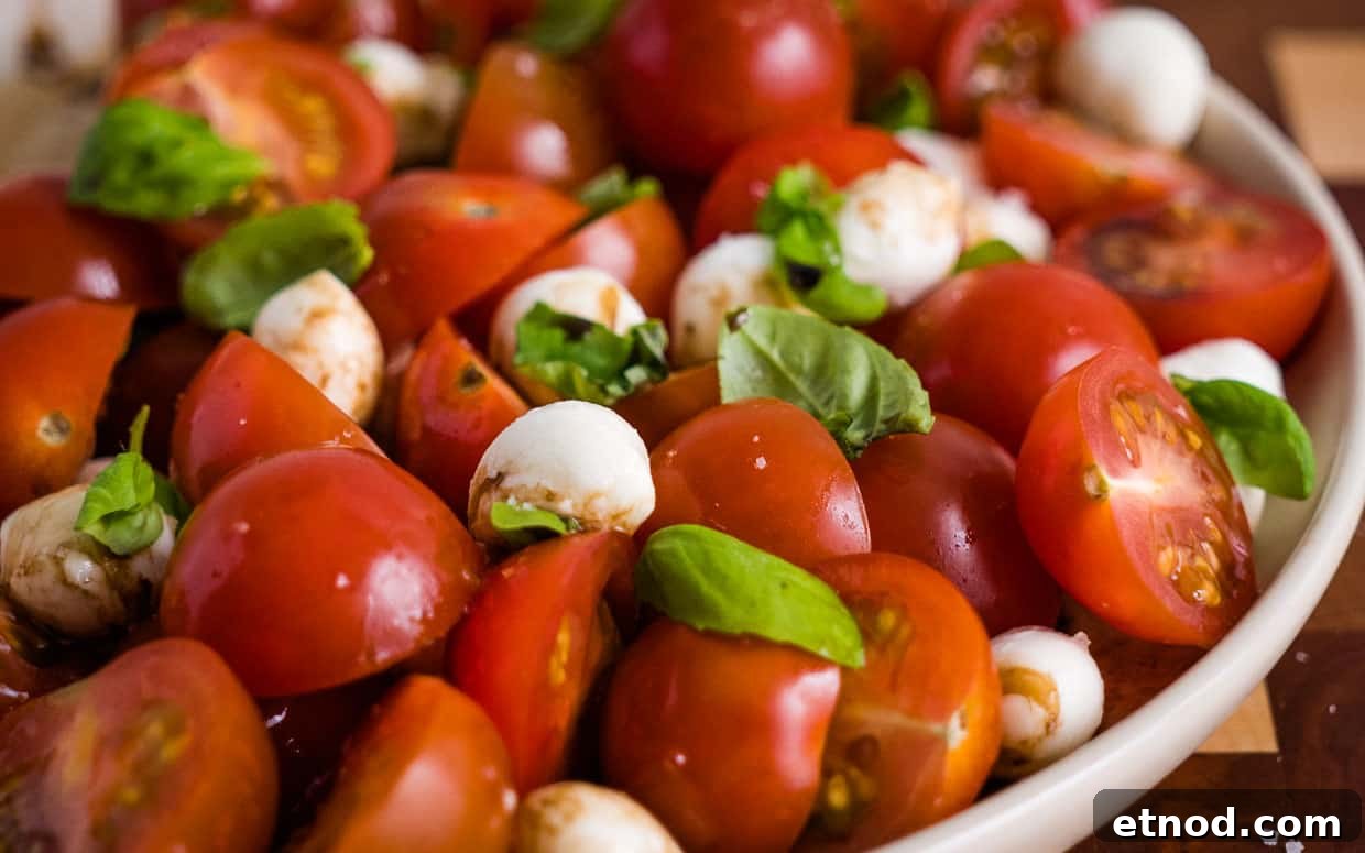 31 Forgotten Grandma Potluck Recipes Worth Bringing Back 26 Caprese salad with tomatoes and mozzarella cheese topped with basil.