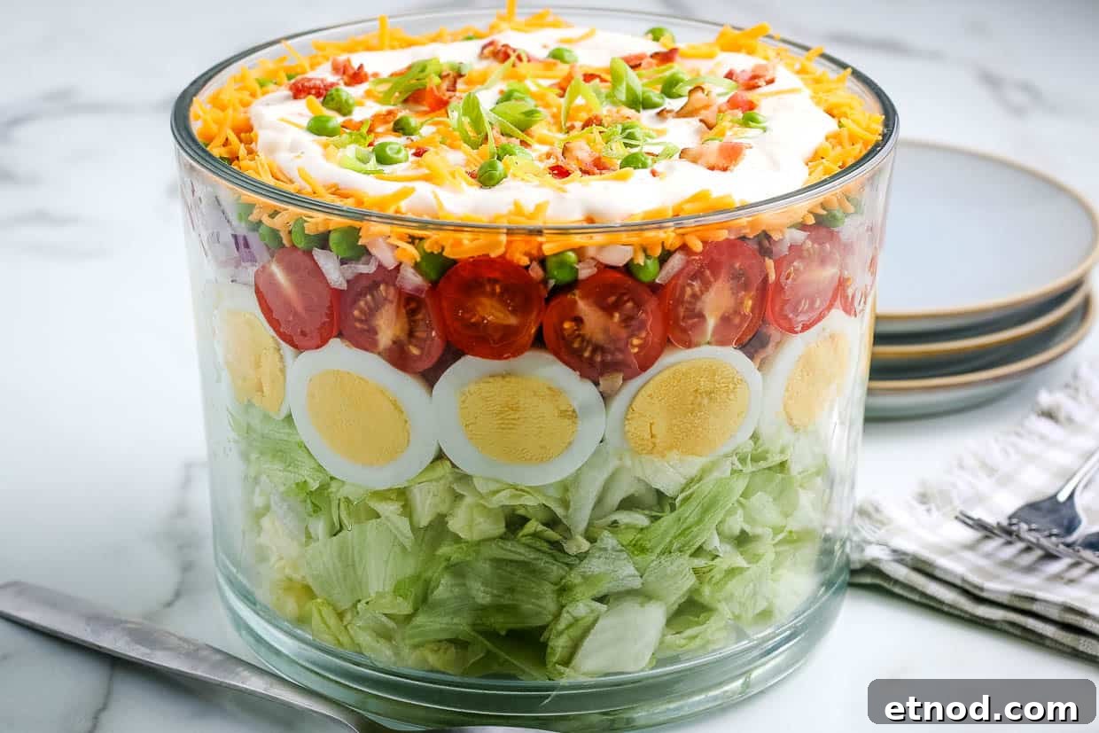 31 Forgotten Grandma Potluck Recipes Worth Bringing Back 31 Seven layer salad in a bowl.