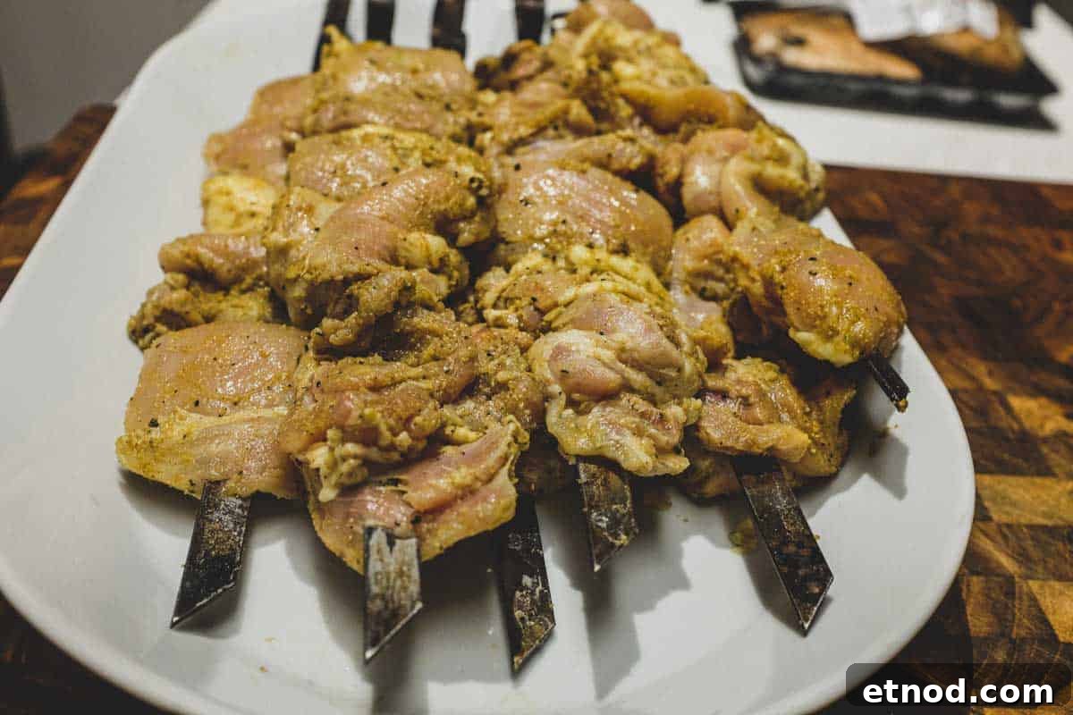 Middle-Eastern-Chicken-Kebabs-Marinade-3 Chicken skewers on a platter marinating in Middle Eastern spices.