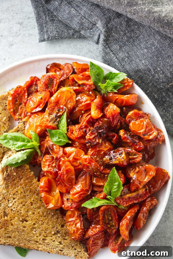 Crispy Air Fryer Cherry Tomatoes Recipe in Minutes 2 A plate of air fryer cherry tomatoes with toast.