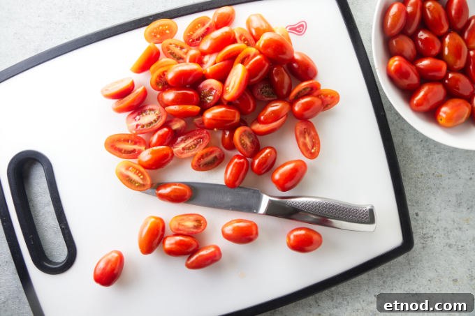 Crispy Air Fryer Cherry Tomatoes Recipe in Minutes 4 Slicing cherry tomatoes in half.