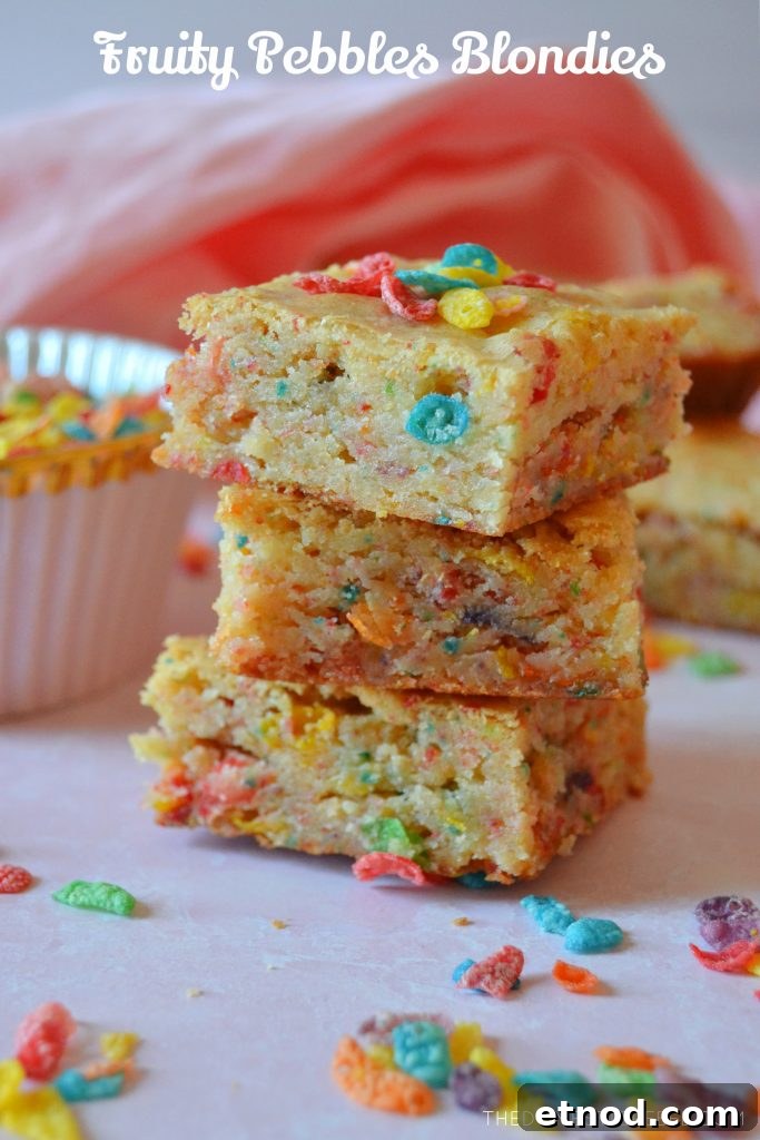 Fruity Pebbles Blondies Recipe: Chewy, Colorful Treats 2 A trio stack of fruity pebbles blondies with pieces of cereal