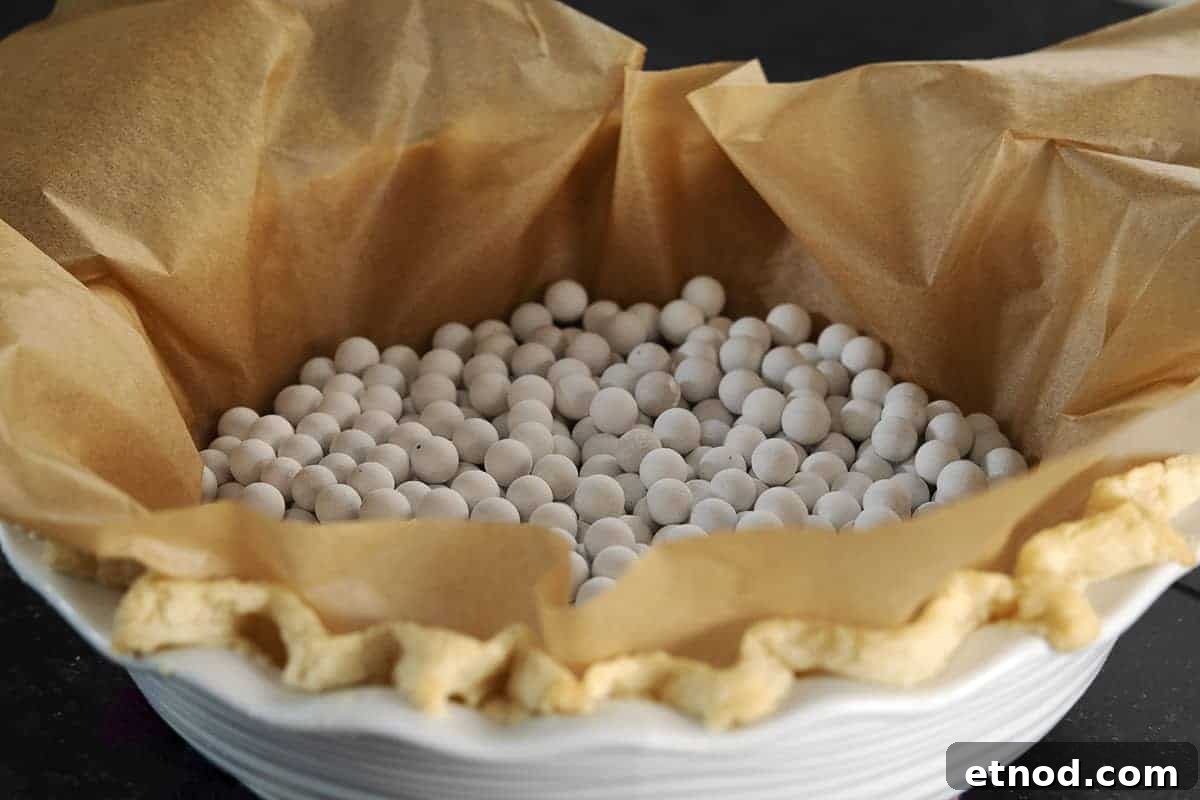 lard pie crust baked with parchment and pie weights