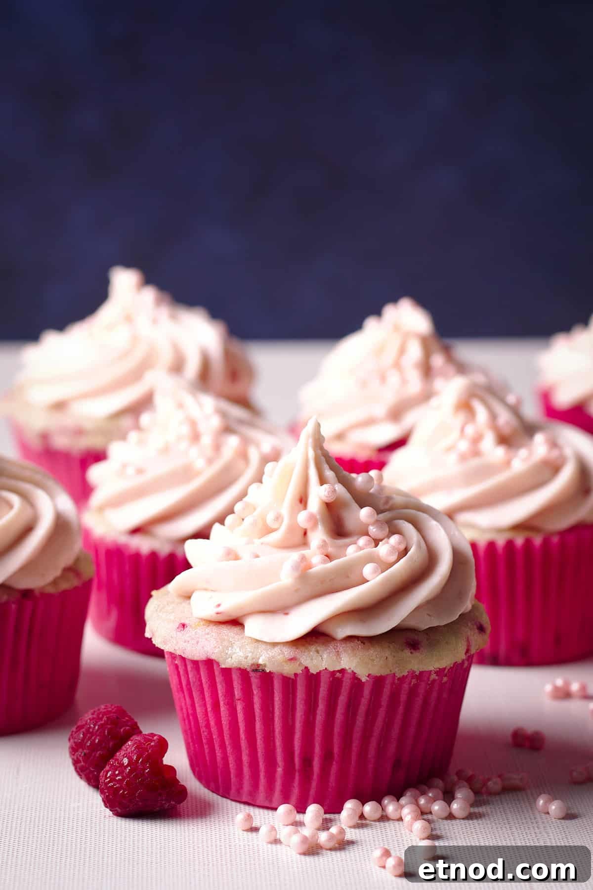 Raspberry Cream Cheese Frosting Recipe for Cakes & Cupcakes 2 Several raspberry cupcakes topped with a swirl of raspberry cream cheese frosting.