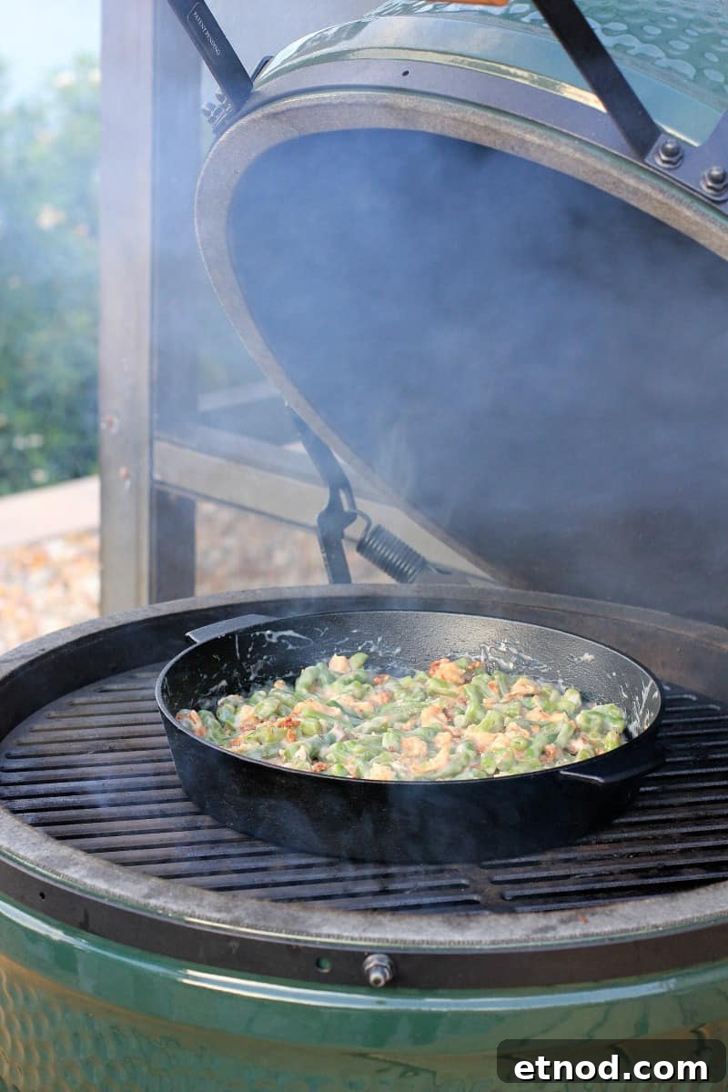 Smoky Grilled Green Bean Casserole with Crispy Bacon 7 cast iron skillet on grill grate in big green egg