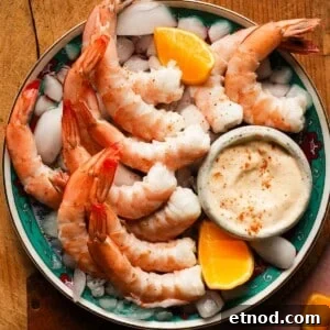 Old Bay Shrimp Cocktail with Creamy Mayo Dip 11 Plate of shrimp with Old Bay mayo and lemon wedges on ice.