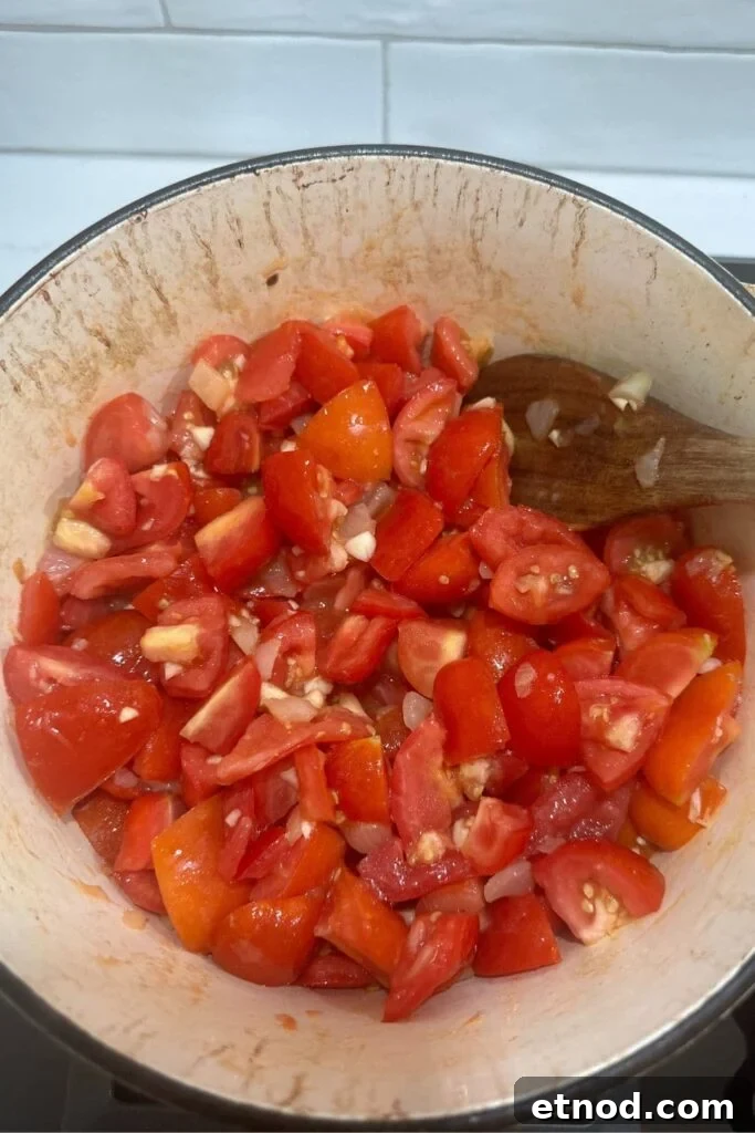 Authentic Homemade Pizza Sauce Recipe for Restaurant-Style Flavor 7 A cream enamel Dutch Oven filled with diced Roma tomatoes and onions - this is the basis of the best homemade pizza sauce recipe for sourdough pizza.