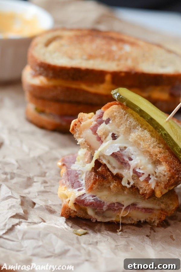 A sandwich cut in half, with meat and cheese