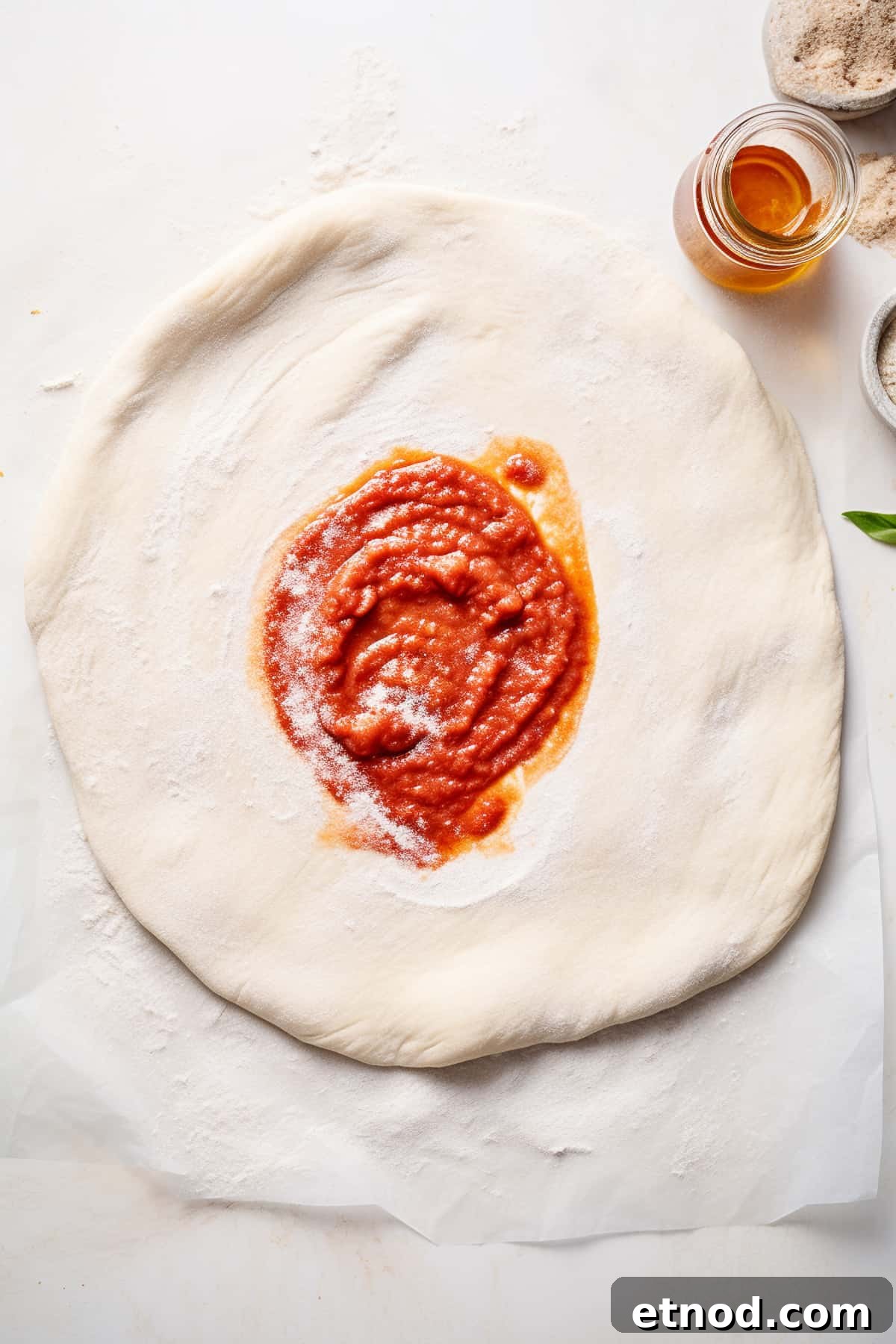 Homemade Chorizo Pizza Recipe: Crispy Thin-Crust Flavor 6 Pizza dough with sauce spread on it.