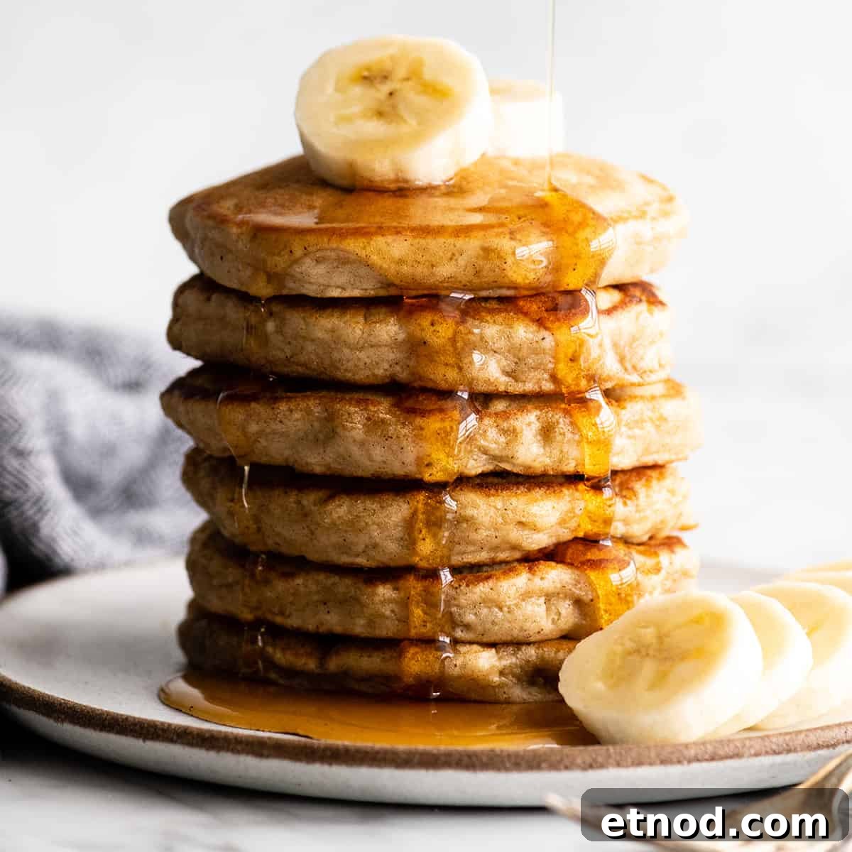 Front view of a stack of banana pancakes front view of a stack of 6 banana pancakes with syrup
