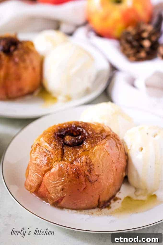 Warm Cinnamon Baked Apples with Caramel Drizzle 7 The finished dessert on a plate with vanilla ice cream.