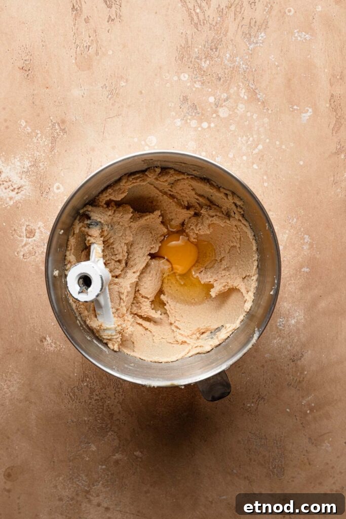 A mixing bowl with creamed butter and an egg.