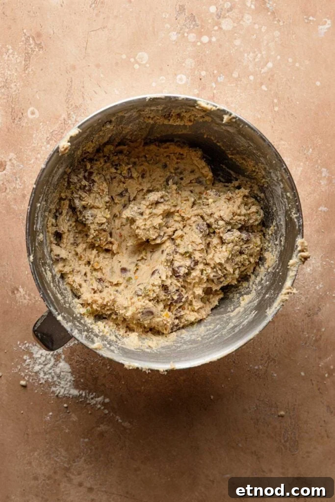 A mixing bowl with chocolate chip pistachio cookie dough.