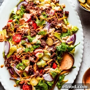 Overhead image of a Big Mac salad served on an oval white platter.