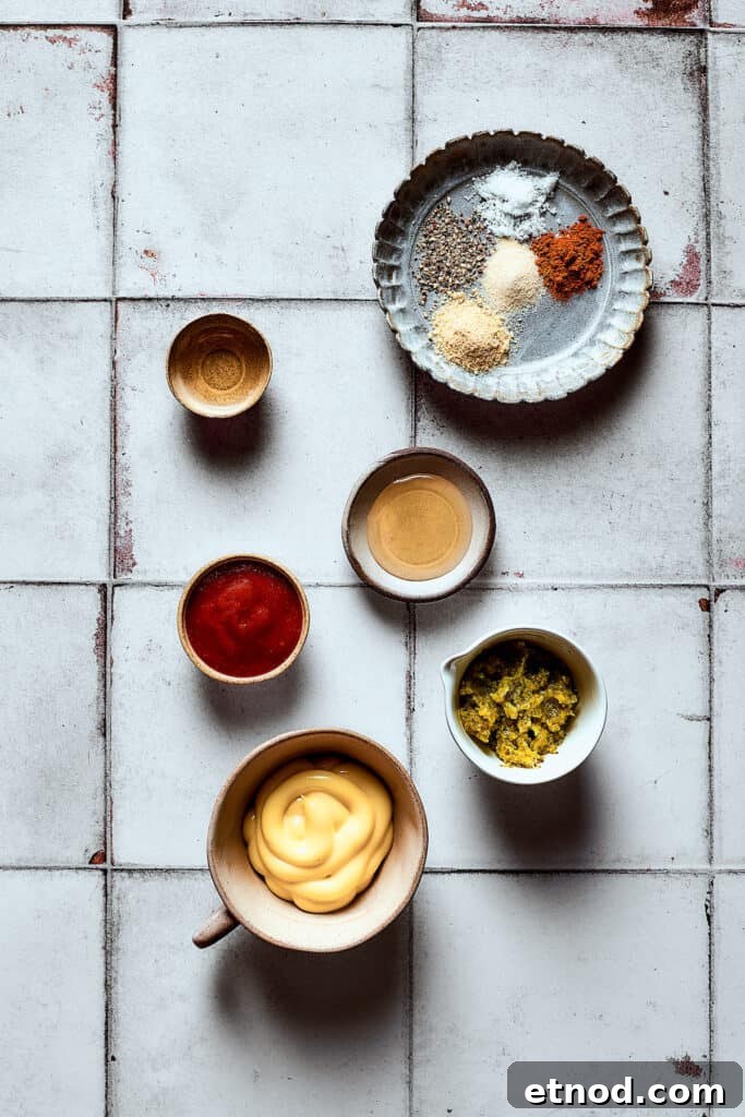 This Big Mac Salad brings all the classic flavors you love but with a healthier twist. It's a guilt-free way to satisfy your burger cravings. Dressing ingredients measured and arranged on a work surface.