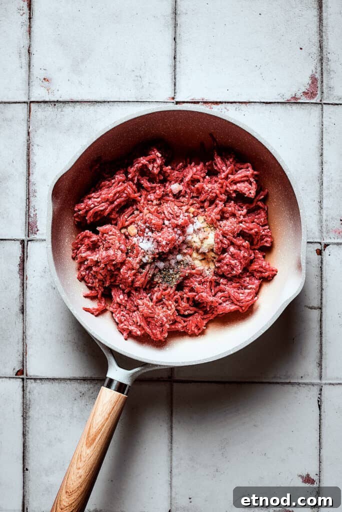 This Big Mac Salad brings all the classic flavors you love but with a healthier twist. It's a guilt-free way to satisfy your burger cravings. Cooking ground beef and seasonings in a skillet.
