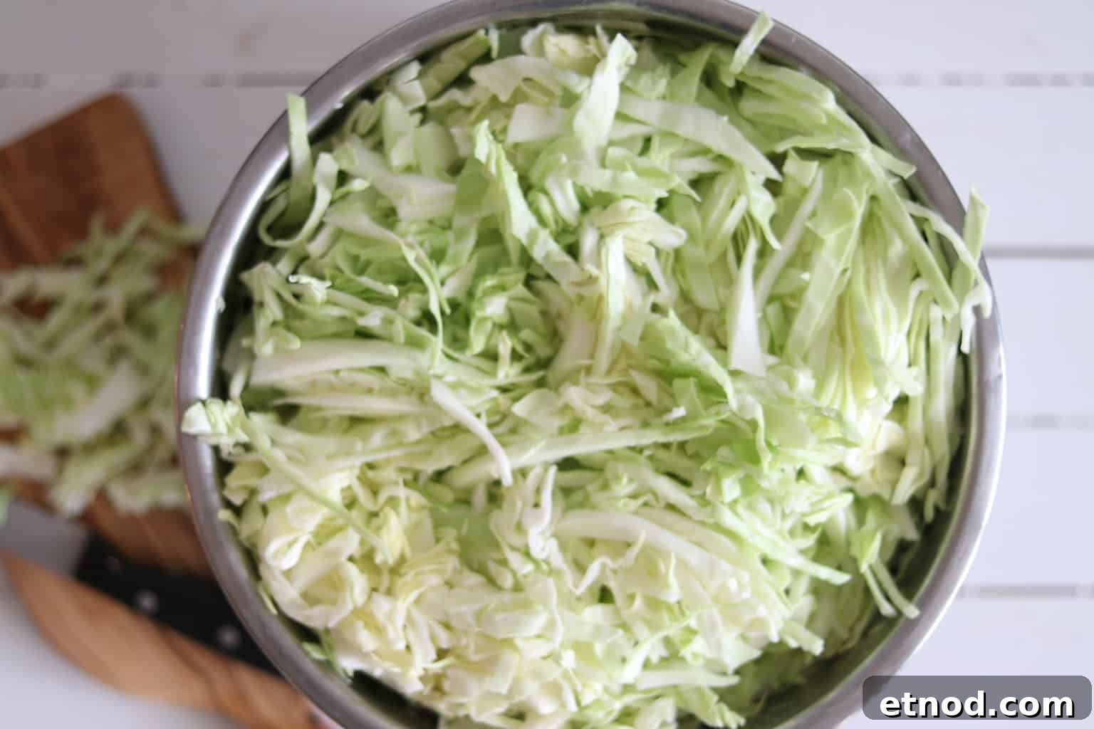 Quick 2-Ingredient Sauerkraut Recipe for Tangy Homemade Ferment 4 Shredded cabbage in large bowl.