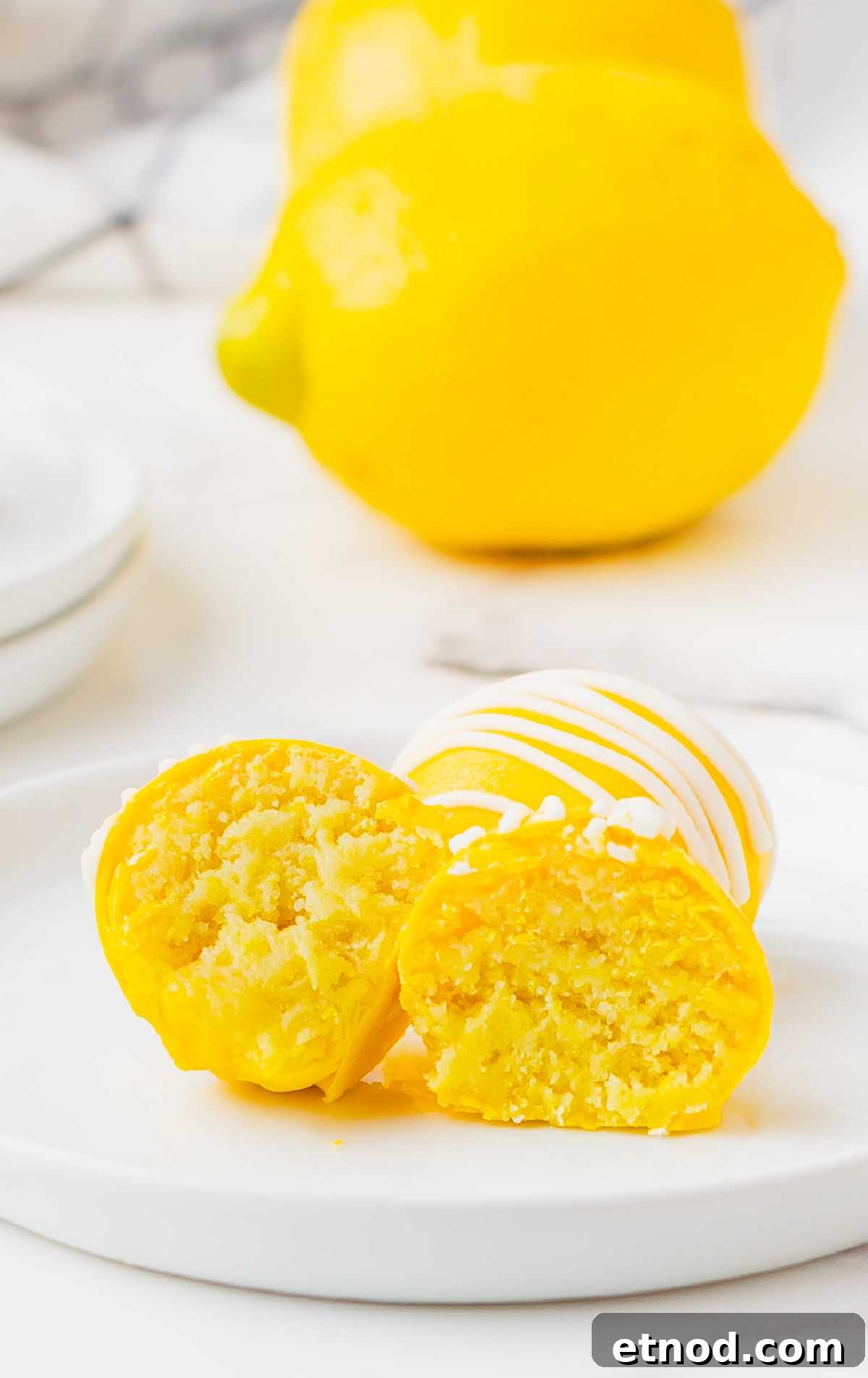 Mini Lemon Cheesecake Bites: Creamy No-Bake Dessert Recipe 7 a close up shot of a couple of Lemon Cheesecake Bites with one split in half
