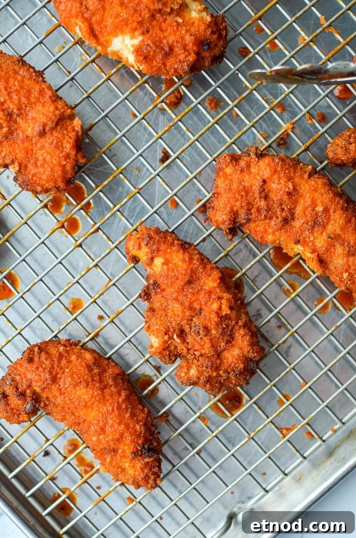 Crispy Buffalo Chicken Tenders in the Air Fryer 9 A wire rack with buffalo chicken tenders on it.