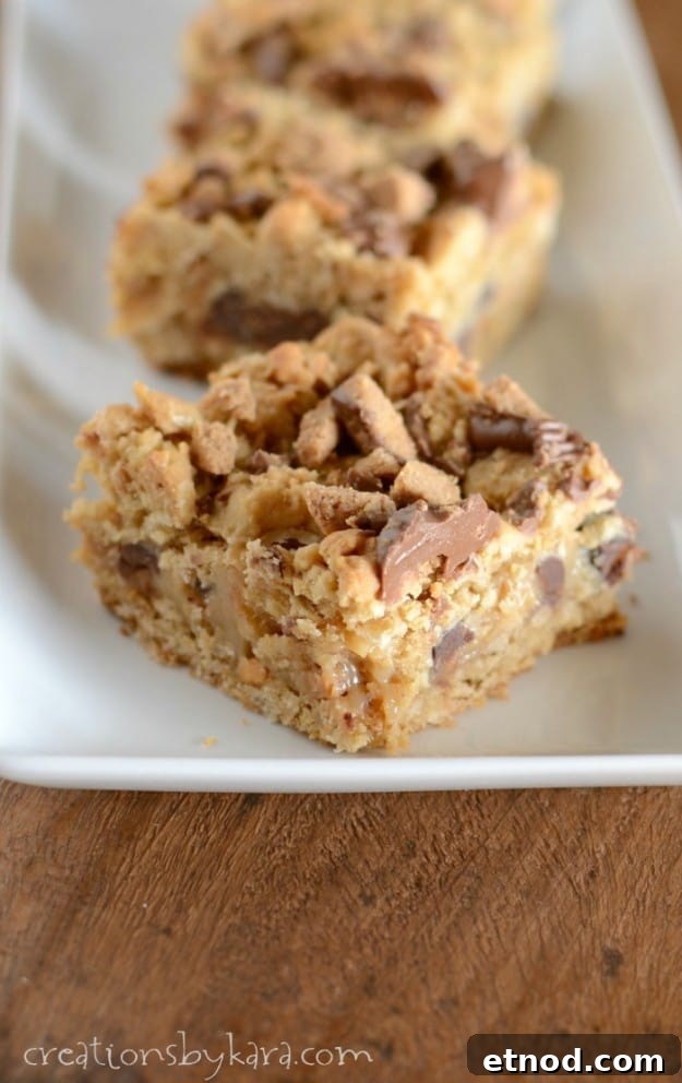 Chocolate and peanut butter fans alike will love these ooey gooey Chocolate Peanut Butter Layer Bars! peanut butter caramel bar on a white tray