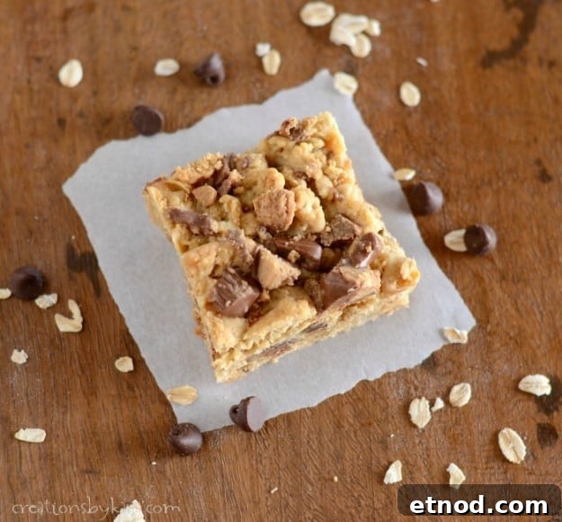 Reese's Peanut Butter Caramel Bars - Loaded with peanut butter, sweetened condensed milk, oats, and chocolate, these decadent bars are sure to satisfy any sweet tooth! overhead shot of oatmeal Reeses Peanut Butter Caramel Bars on waxed paper
