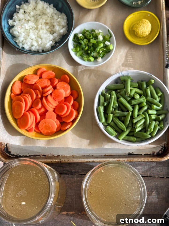 Healing Ginger Chicken Soup Recipe for Cold Relief 4 ingredients for chicken soup on a sheet tray