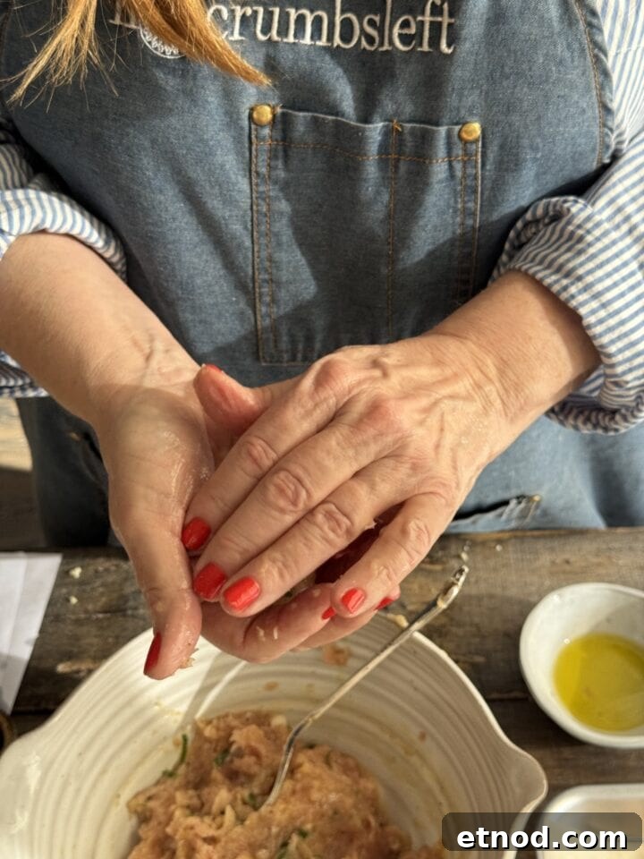 Healing Ginger Chicken Soup Recipe for Cold Relief 7 teri forming a chicken meatball in her hands