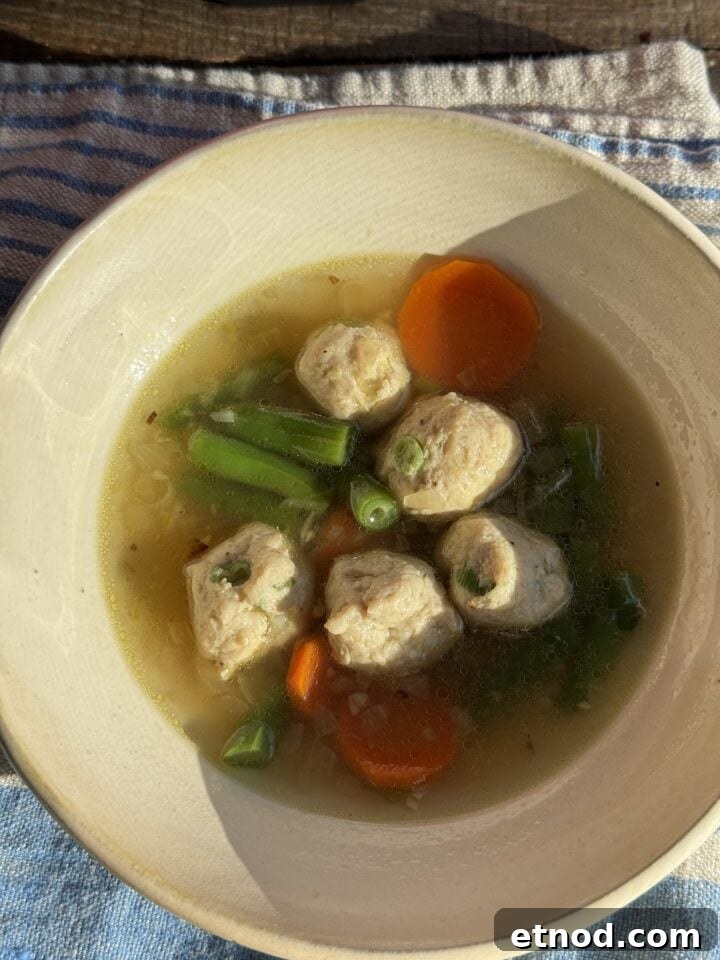 Healing Ginger Chicken Soup Recipe for Cold Relief 9 chicken soup with ginger in a white bowl
