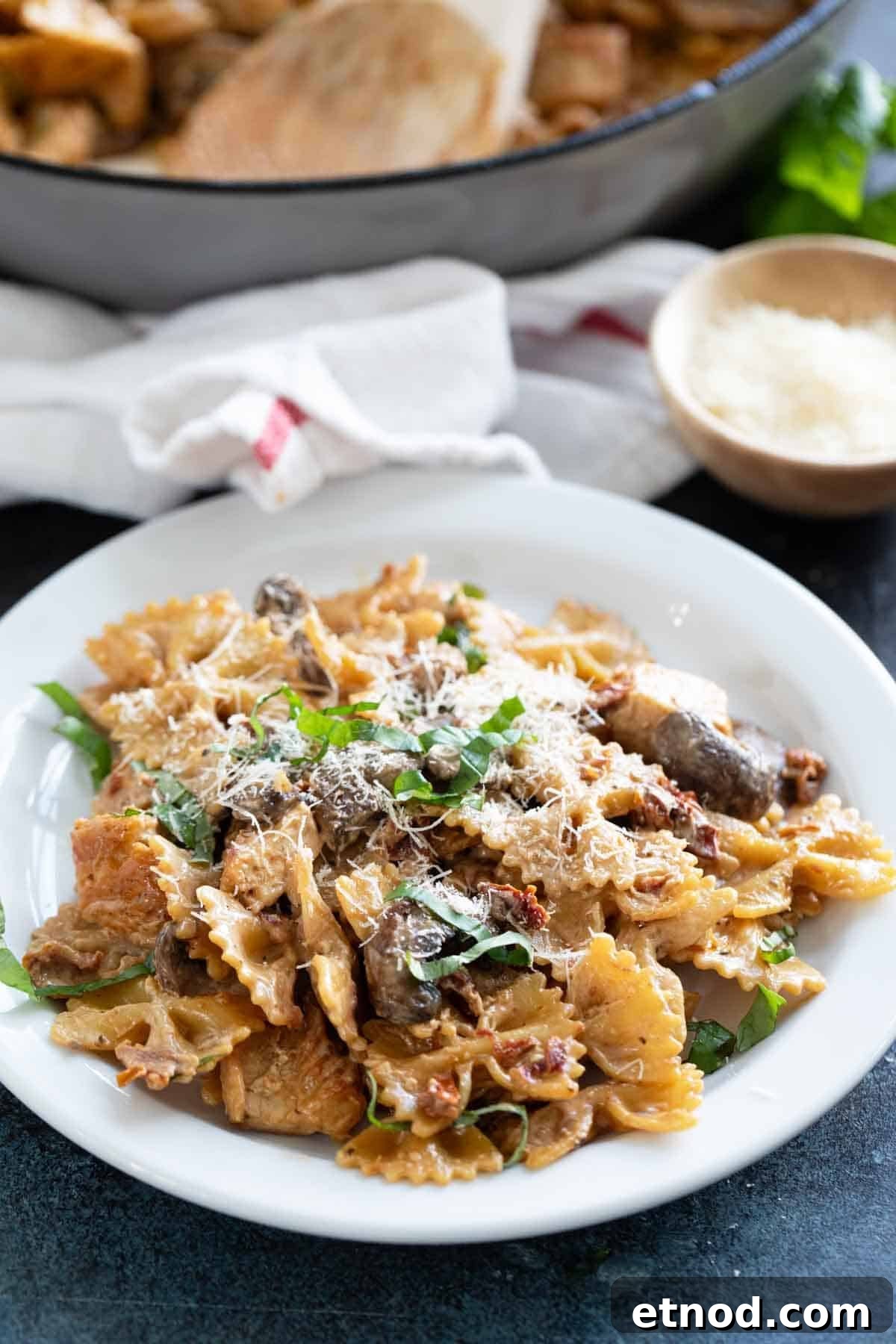 Creamy Milano Chicken Pasta Recipe for Weeknight Dinners 9 Serving of Chicken Pasta Milano on a plate, topped with parmesan cheese.
