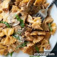 Creamy Milano Chicken Pasta Recipe for Weeknight Dinners 10 Plate with Chicken Pasta Milano with a fork.