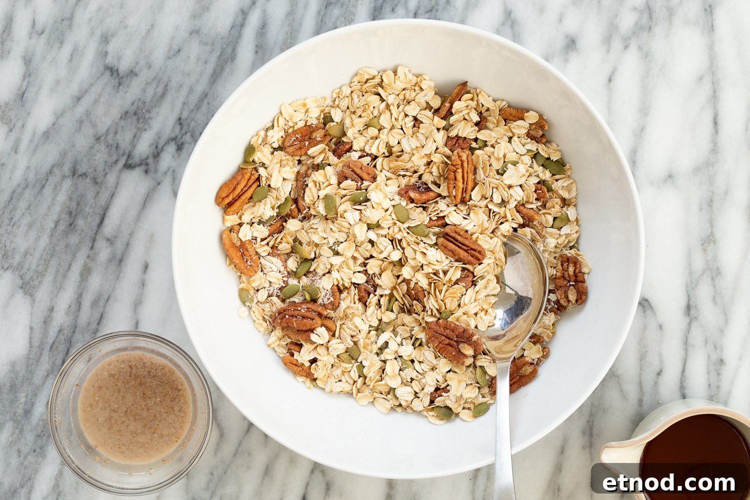 Ingredients for our Maple Pecan Granola in a white bowl