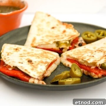 Roasted Red Pepper Quesadillas with Melty Cheese and Cilantro Lime Dip 4 A plate of quesadillas on a table, with Quesadilla and Cheese