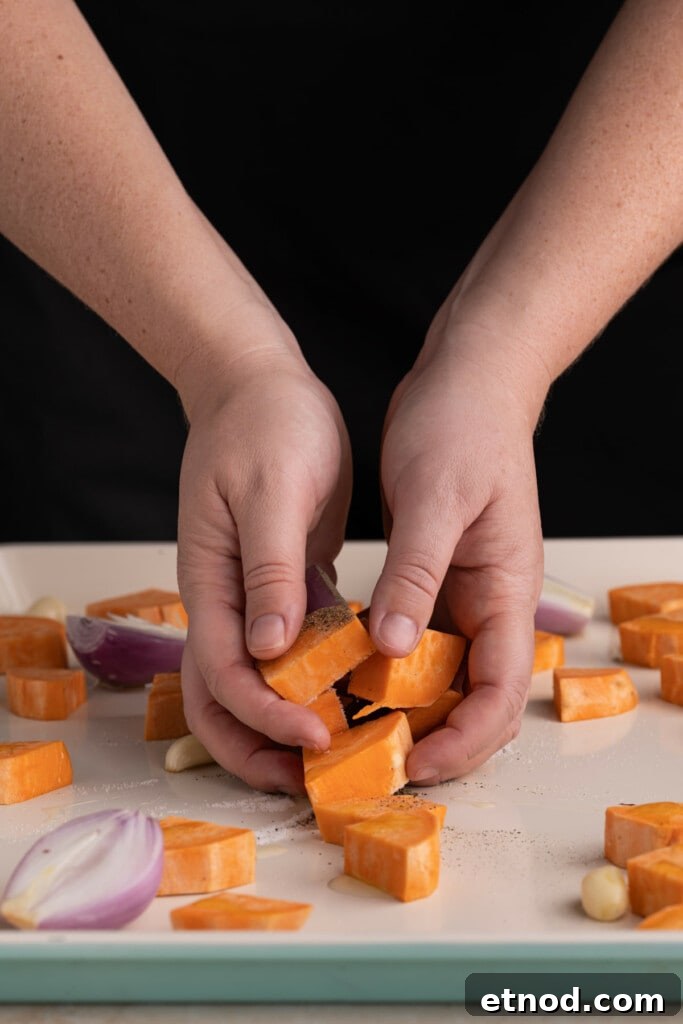 30-Minute Creamy Sweet Potato Pasta Sauce Recipe 6 Using clean hands to coat veggies in olive oil, salt, and pepper.