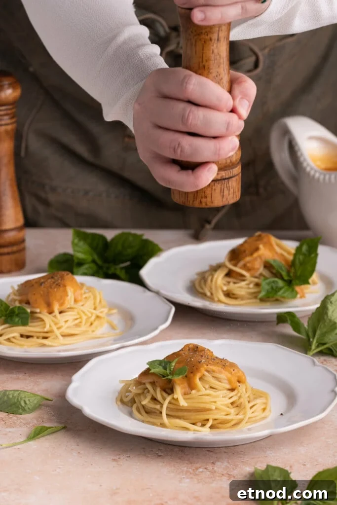 30-Minute Creamy Sweet Potato Pasta Sauce Recipe 8 Cracking fresh black pepper over pasta with Sweet Potato Pasta Sauce