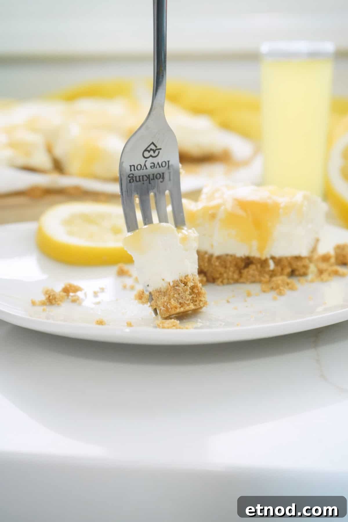 Limoncello Cheesecake Bars (No-Bake) 8 Limoncello Cheesecake with bite on fork