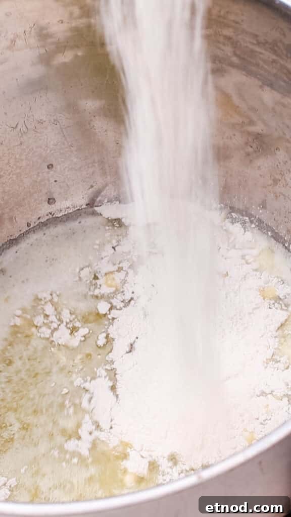 Combining butter and flour in a saucepan.