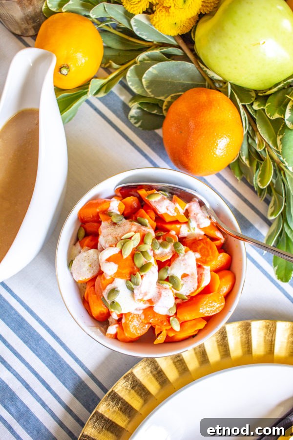 Roasted Carrots with a Ginger Sauce 2 Roasted Carrots with a Ginger Yogurt Sauce and Pepitas | This simple recipe for Roasted Carrots with a Ginger Yogurt Sauce and Pepitas turns carrots into a show stopping side dish. Serve this for #Thanksgiving or along with a weeknight meal. Your family will love the sweet and spicy flavors of this vegetable recipe.