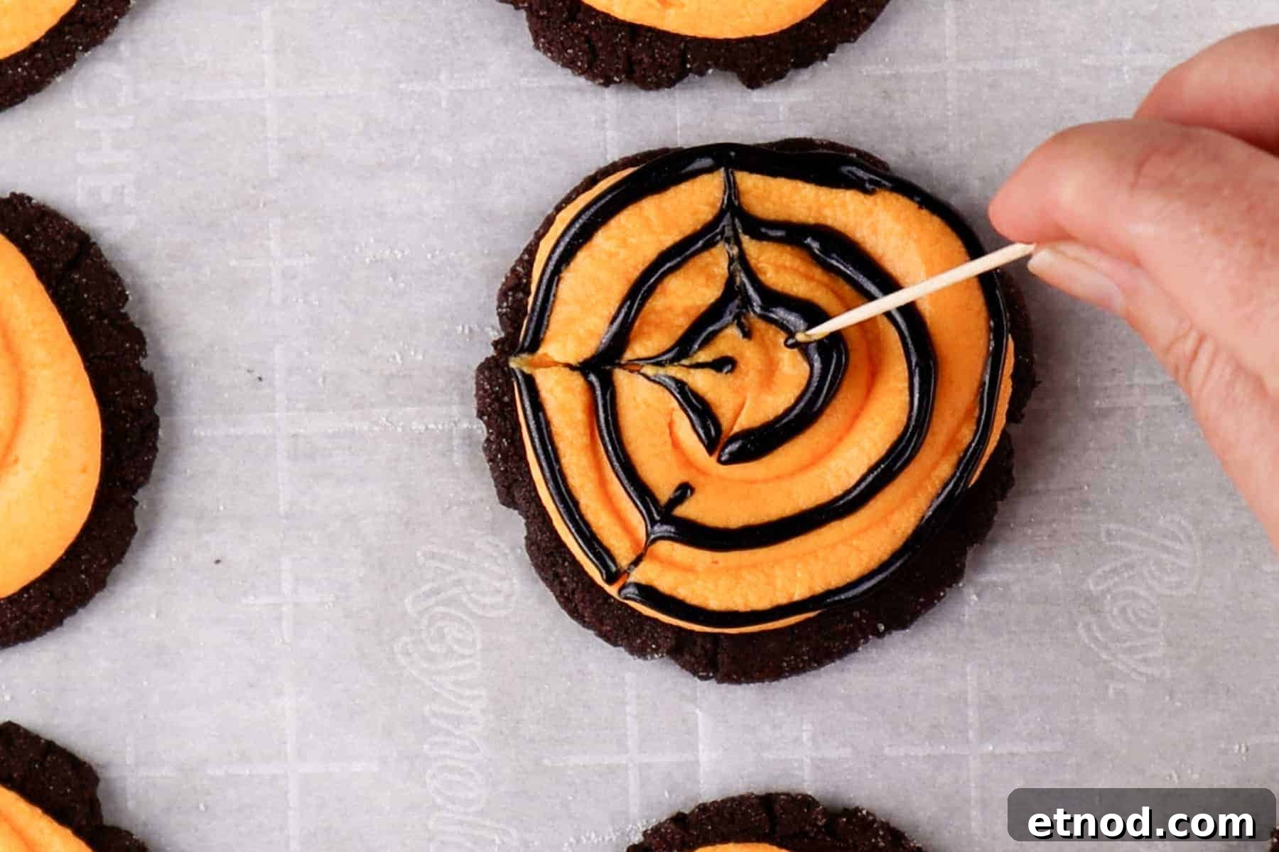Drag a toothpick through the black circles to create lines and a web effect.