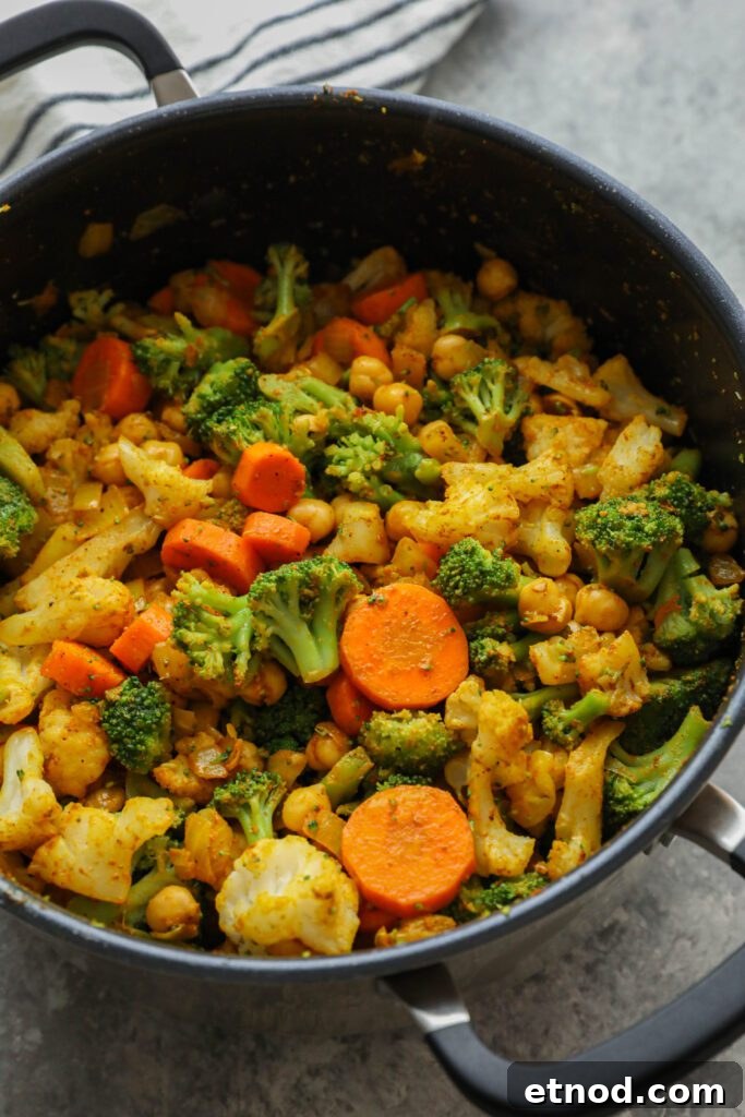 Creamy Vegan Vegetable Korma Recipe — Flavorful Indian Curry 6 Vegan Vegetable Korma cooked in pot by Flora & Vino