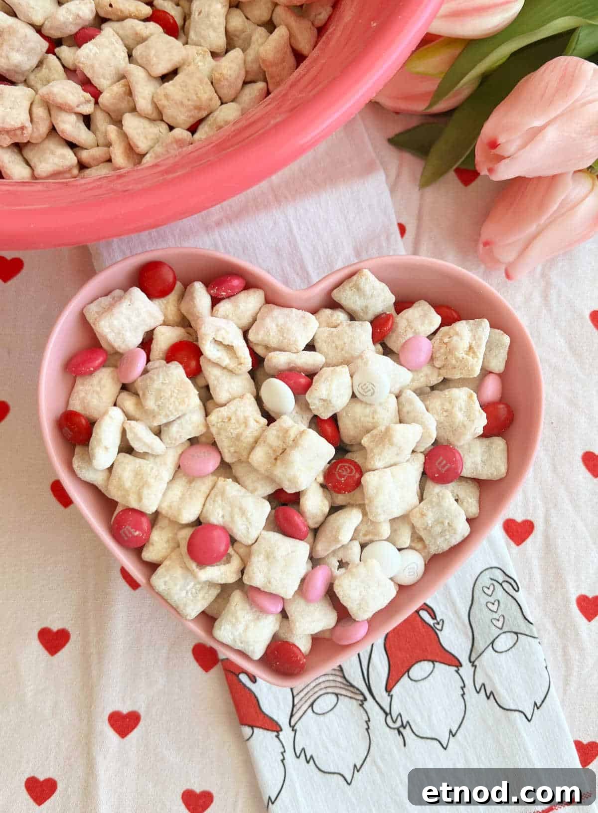 Valentine’s Day Puppy Chow Recipe (Muddy Buddies Treats) 2 Valentine puppy chow in a pink heart bow.