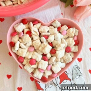 Valentine’s Day Puppy Chow Recipe (Muddy Buddies Treats) 9 valentine's day puppy chow with valentine m&m candy in bowl.