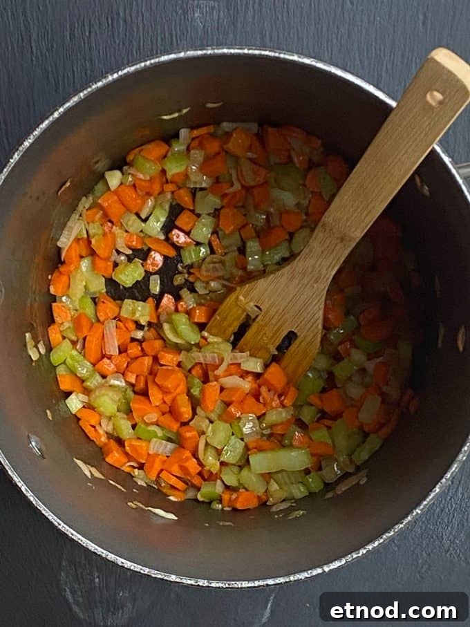 An overhead view of diced vegetables in a pot