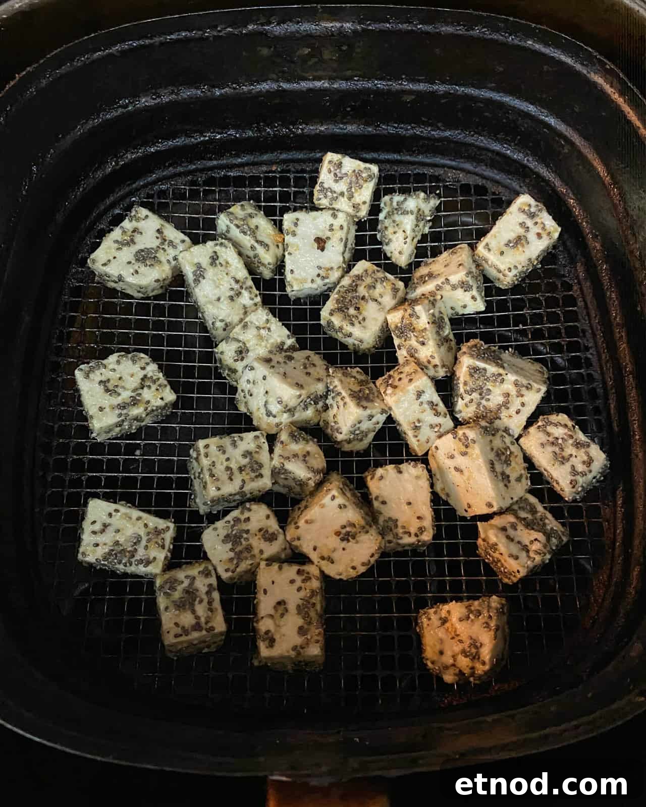 Crispy Air Fryer Tofu Coated with Chia Seeds for Extra Crunch 7 Image showing crispy chia tofu cubes in the air fryer basket.