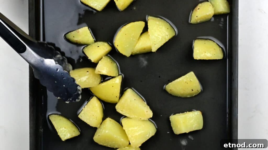 Crispy Roast Potatoes Cooked in Goose Fat 7 Adding parboiled potatoes to roasting tray with hot goose fat