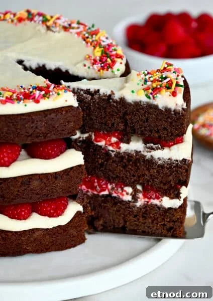 Decadent Chocolate Loaf Cake Recipe for Moist, Rich Results 16 A three-tiered chocolate cake with cream cheese frosting and fresh raspberries.