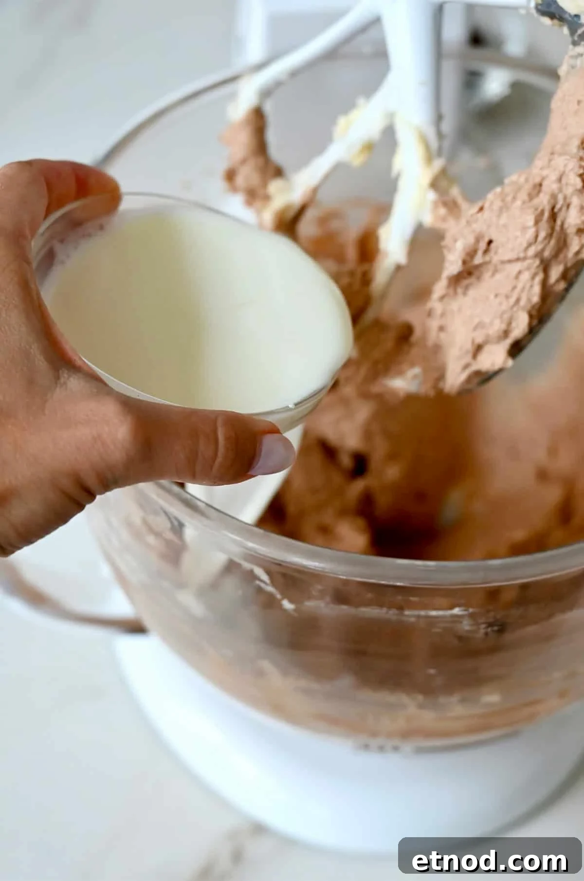 Decadent Chocolate Loaf Cake Recipe for Moist, Rich Results 7 Adding whole milk to the chocolate loaf cake batter to thin it.